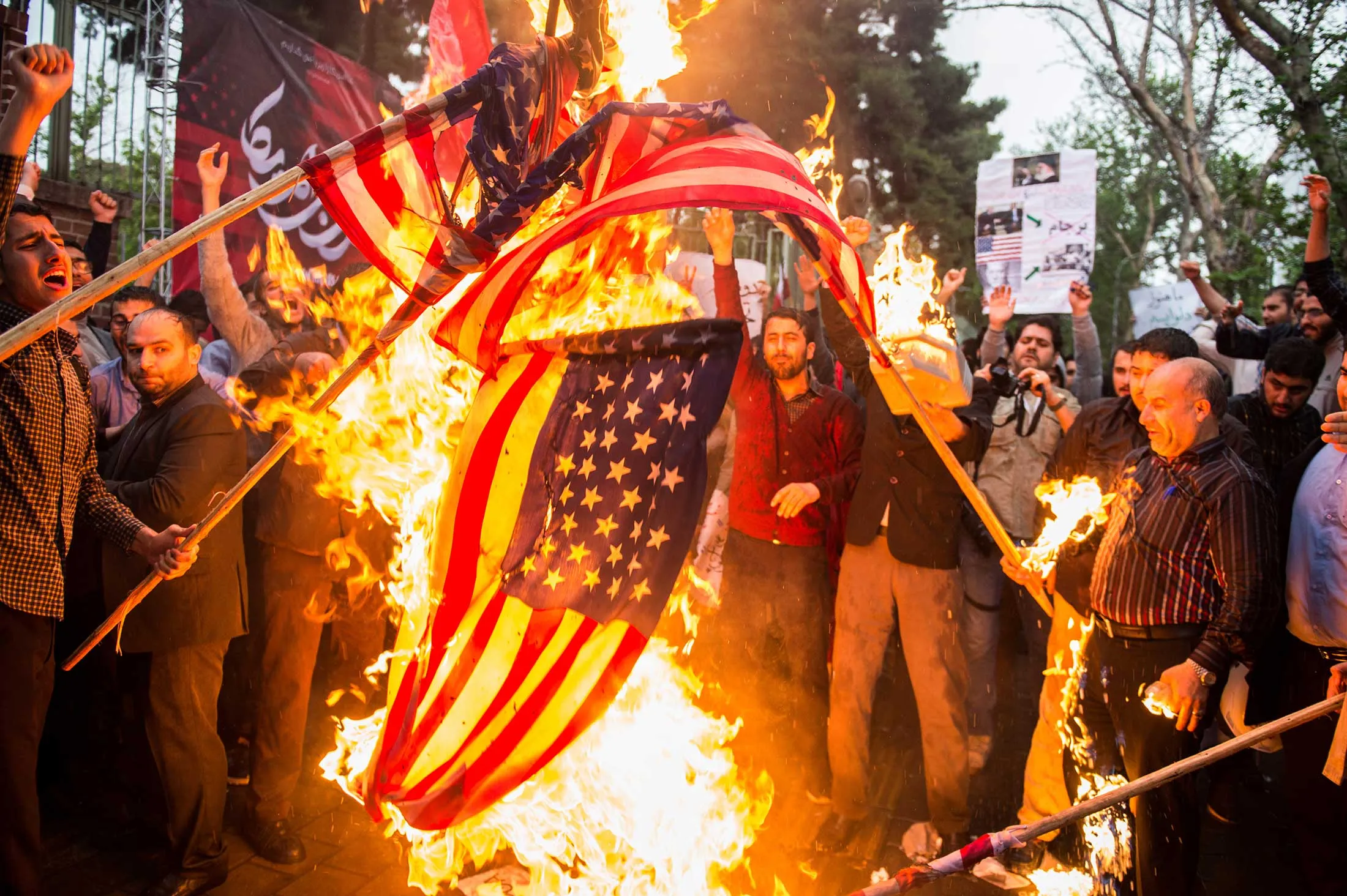 Iranians burn American flags during a demonstration outside the former U.S. embassy in Tehran on May 9, 2018.