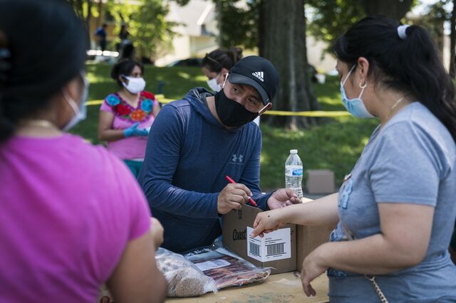 Mariano Espinoza distributes food to local residents during a pop-up grocery event at Powderhorn Park in Minneapolis on July 24, 2020. 