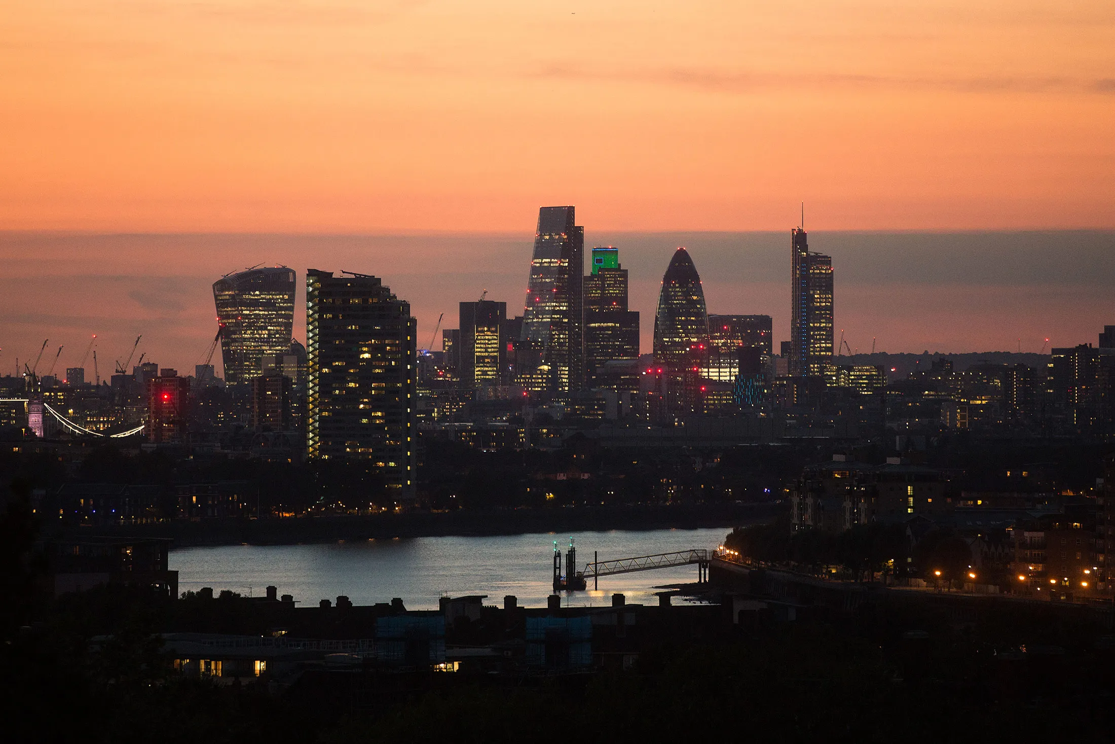 Lights illuminate skyscrapers including 20 Fenchurch Street also known as the 'Walkie Talkie', The Leadenhall building, also known as the 'Cheesegrater,' Tower 42, 30 St Mary Axe also known as 'the Gherkin,' and The Heron Tower, as the sun sets in the City of London, U.K., on Tuesday Aug. 30, 2016. Few places in greater London encapsulate the challenges posed by Britain's vote to exit the European Union quite like Canary Wharf, home to JPMorgan Chase &amp; Co., Citigroup Inc. and HSBC Holdings Plc.
