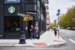A customer wearing a protective mask leaves a Starbucks in Brooklyn, New York.