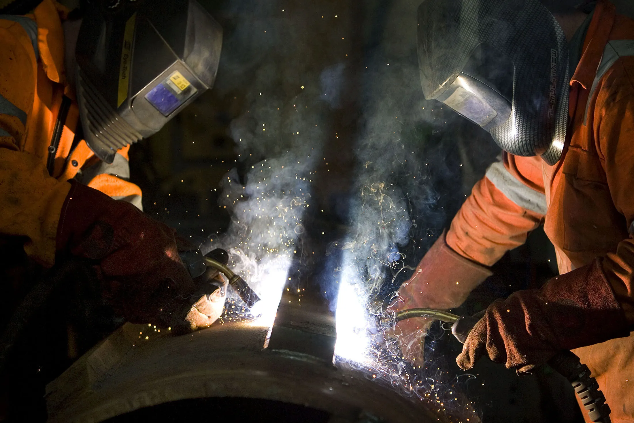 Welders work on pieces of steel at a factory in Rochester, U.K.
