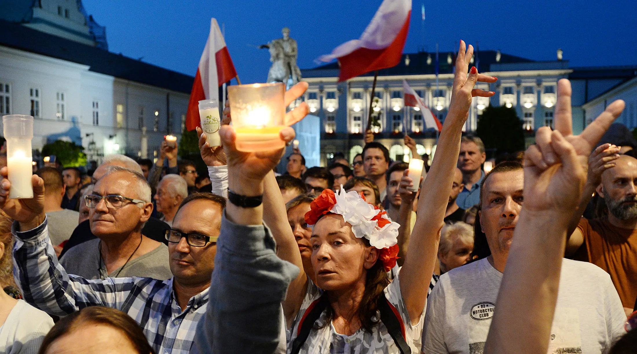 Protesters raise candles during a protest in front of the presidential palace, as they urge President Duda to reject a bill changing the judiciary system, in Warsaw, on July 18.
