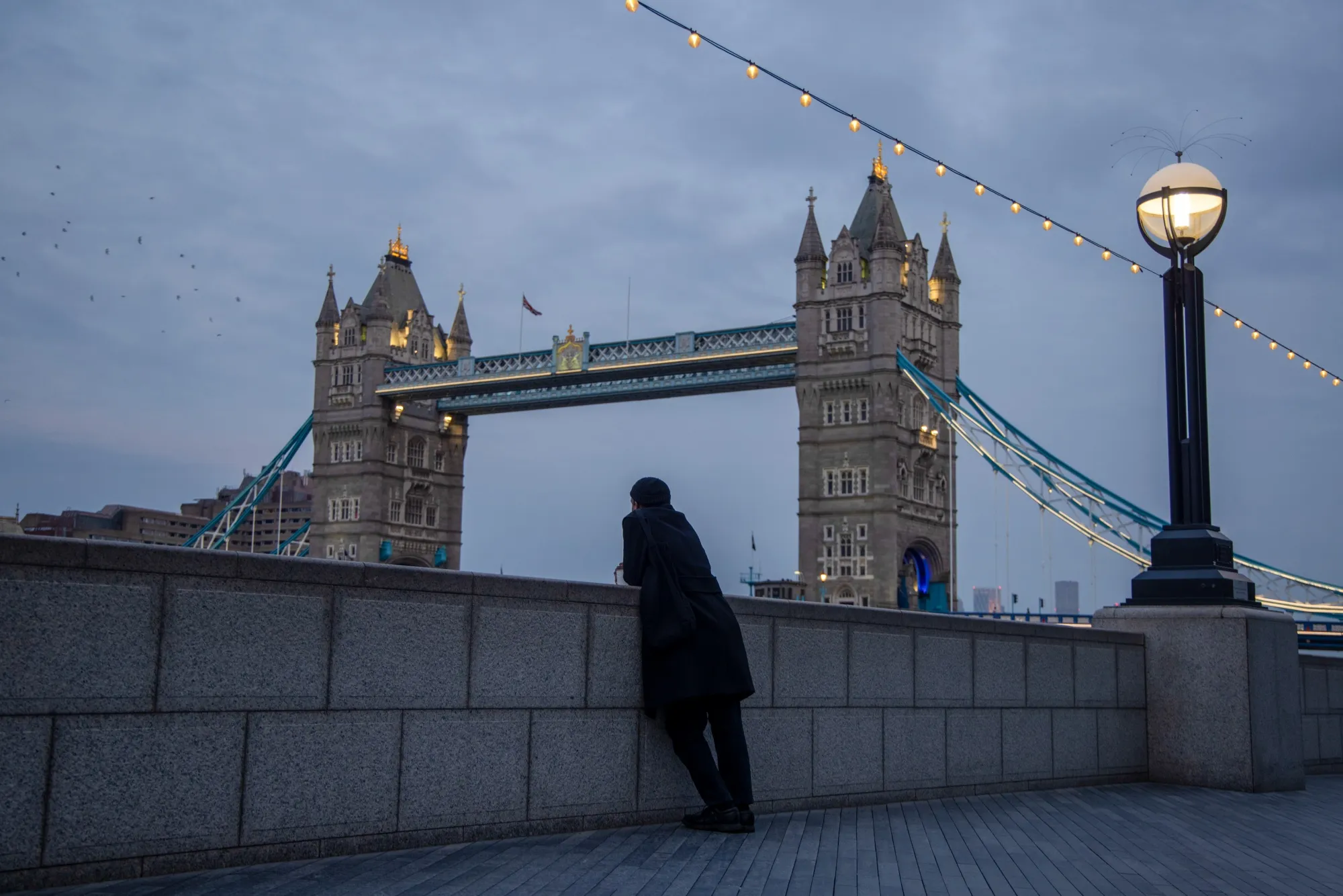 A pedestrian on the Thames Path in the City of London.