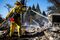 A firefighter works to contain embers on the remains of a house destroyed in the Clayton Fire are seen in Lower Lake, California, August 15th, 2016. A northern California wildfire grew rapidly over the weekend, destroying homes and forcing 4,000 residents to flee, authorities said. / AFP / GABRIELLE LURIE (Photo credit should read GABRIELLE LURIE/AFP/Getty Images)