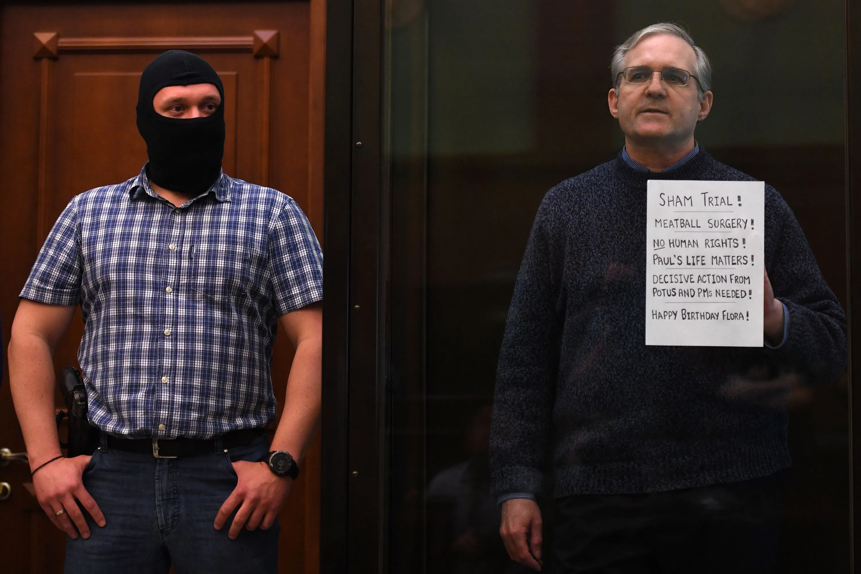 Paul Whelan, right, stands inside a defendants' cage as he waits to hear his verdict in Moscow on June 15.