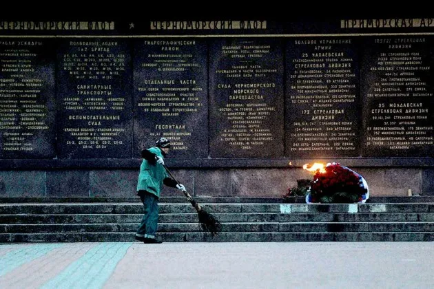 A municipal worker in Crimea cleans the area at the World War II Memorial to the Heroes of the Defense of Sevastopol