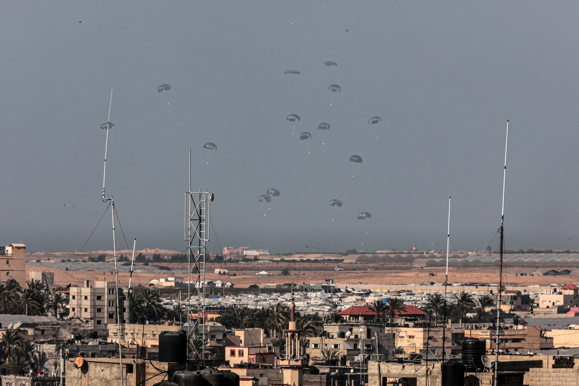 A military aircraft drops humanitarian aid over Rafah and Khan Yunis on Feb. 27.
