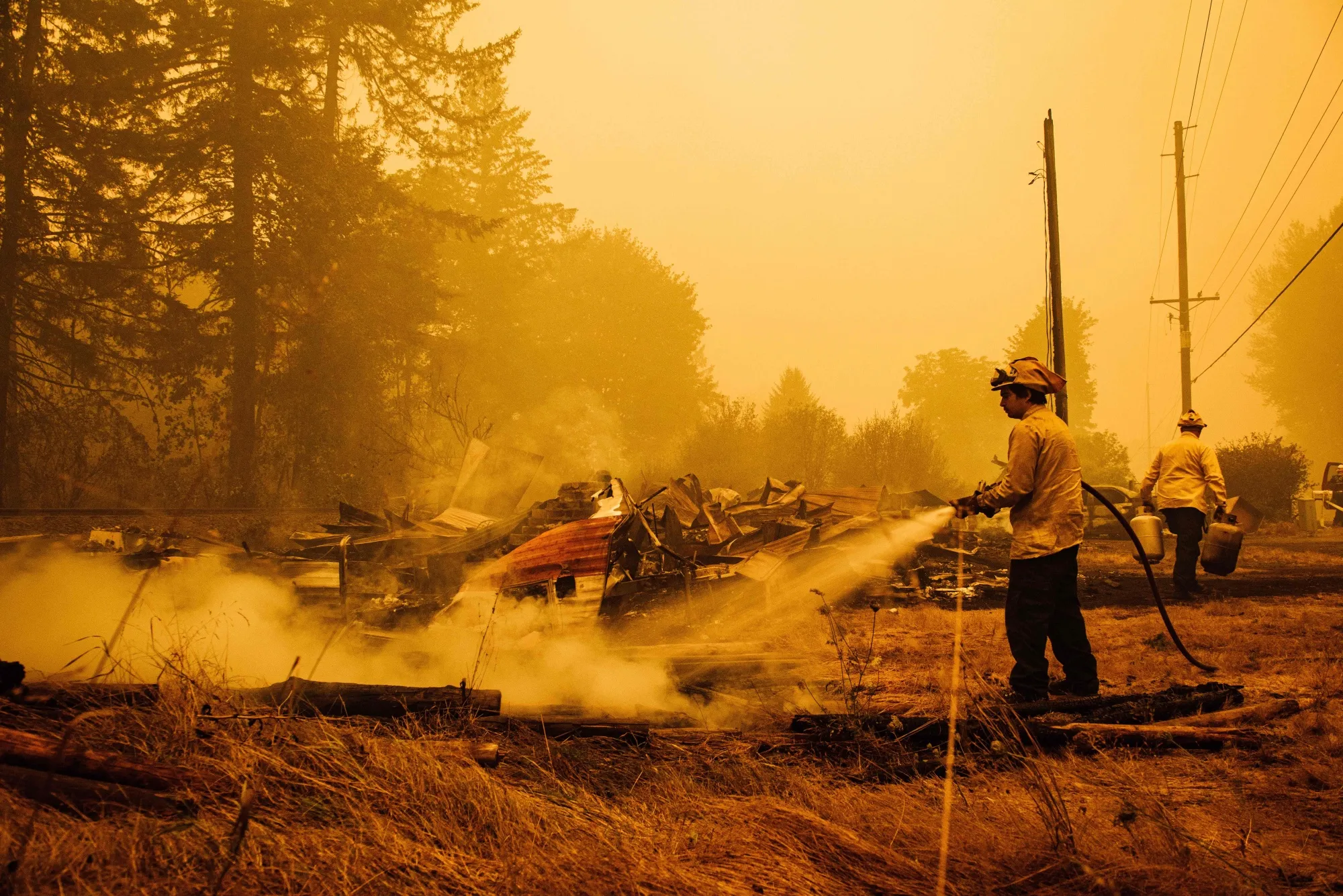 Oregon firefighters put out embers in Mill City, Oregon in September 2020.&nbsp;