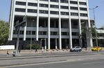 Pedestrians pass the headquarters of the Turkish central bank in Ankara, Turkey.