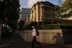 A&nbsp;commuter walks past the Bank of Japan (BOJ) headquarters in Tokyo, Japan.