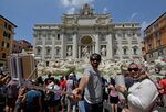 Tourists at Rome's Trevi fountain, where paddling or picnicking (but not selfie stick use) now incurs a fine