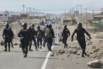 Policemen patrol the Pan-American highway as demonstrators hold a blockade in Peru, on Jan.&nbsp;12