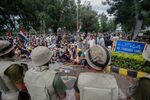 Pakistani security forces stand guard as supporters of anti-government cleric Tahir-ul-Qadri stage a protest Monday.