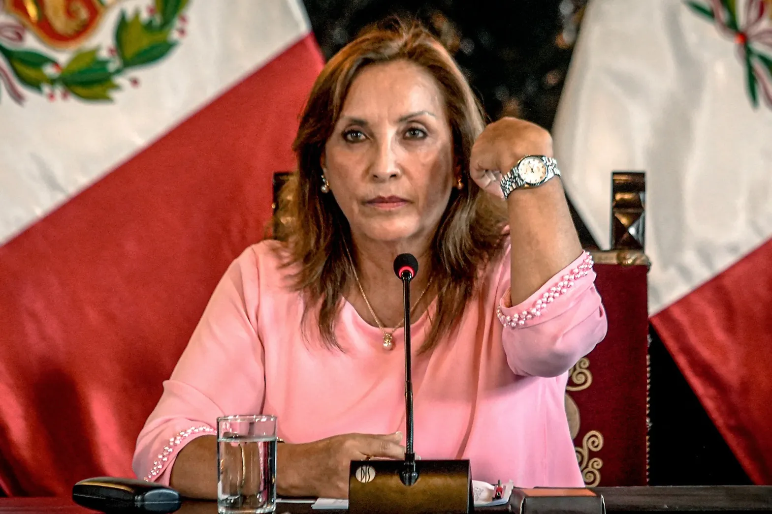 Peru's President Dina Boluarte shows a watch during a news conference at the government palace, after her statement to the prosecutor's office, in Lima on April 5.