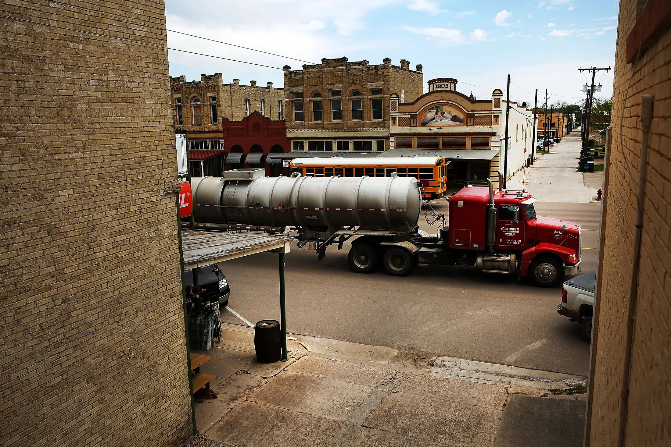 Oil trucks rumble through Cuero, Texas.
