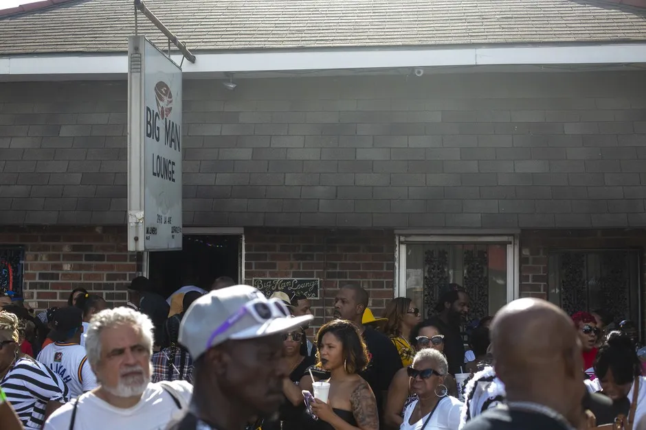 Second Line revelers take a break outside of Big Man's Lounge in New Orleans.