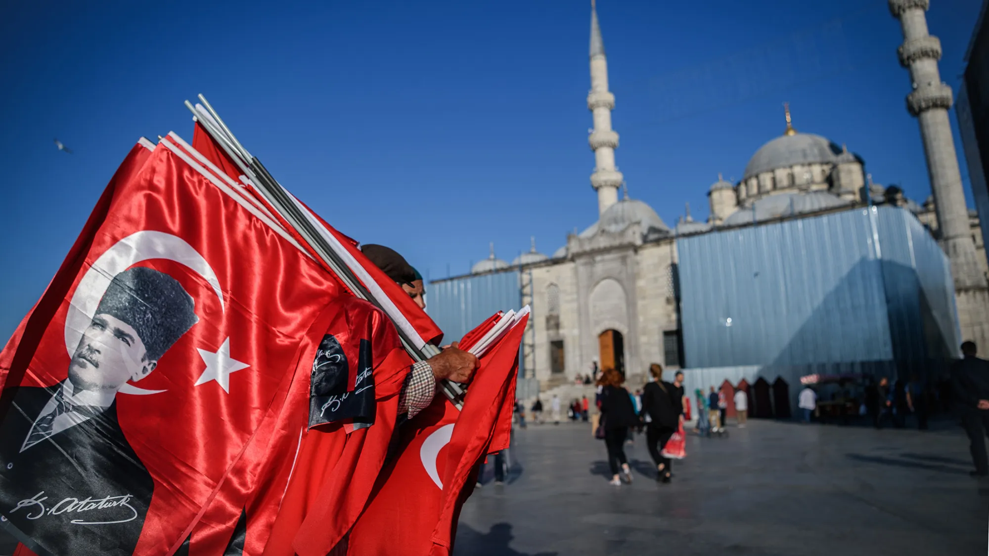 A man sells flags of Mustafa Kemal Ataturk, founder of modern Turkey, near the new mosque at Eminonu district in Istanbul, on June 9, 2016.
