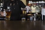 A bartender&nbsp;pours a shot of mezcal at a restaurant in Houston.