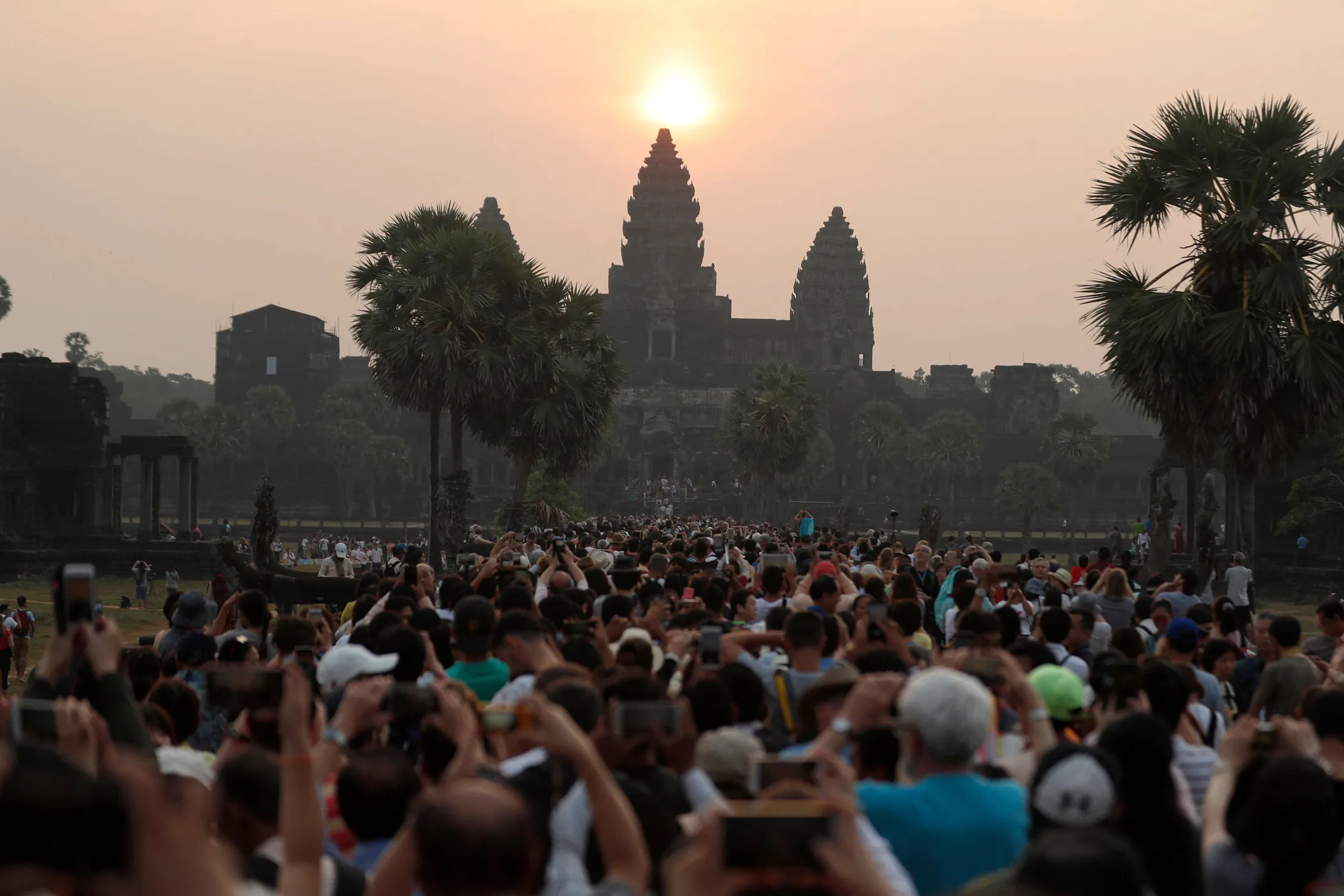 Throngs of tourists mob the Angkor Wat temple complex in Cambodia, one of Chinese vacationers’ favored foreign destinations, in 2018.