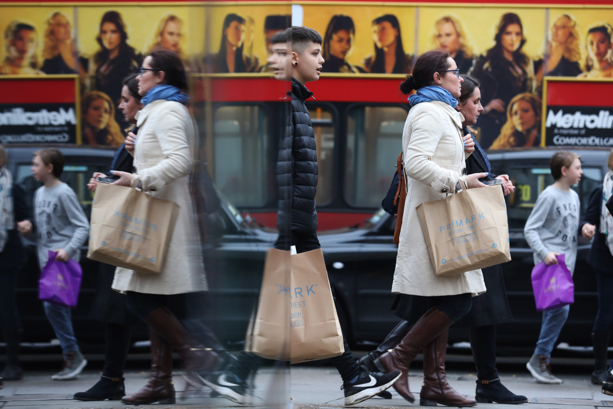Shoppers exit a clothing store&nbsp;in London,
