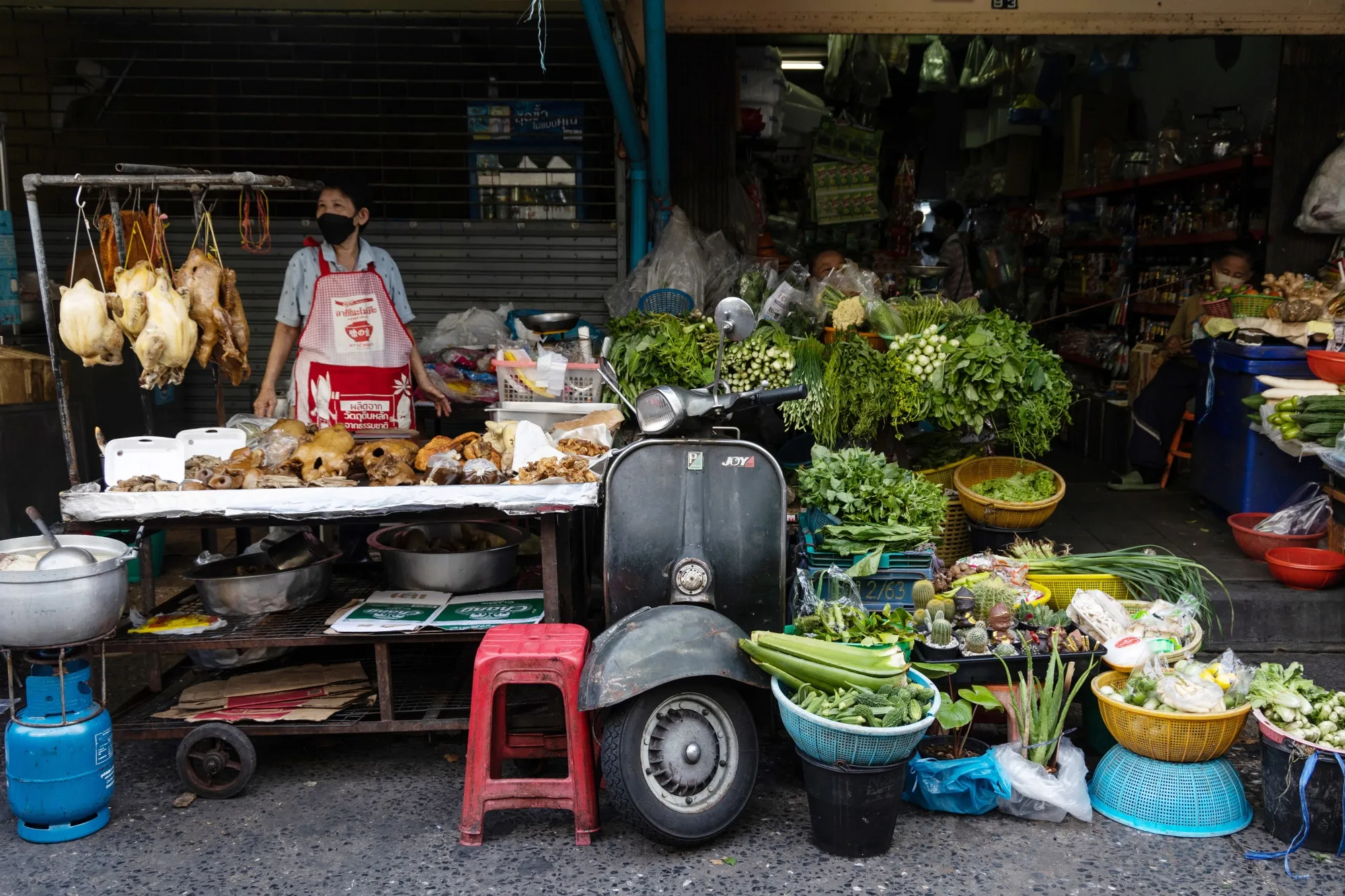 A market vendor waits for customers at a market in Bangkok on April 26.