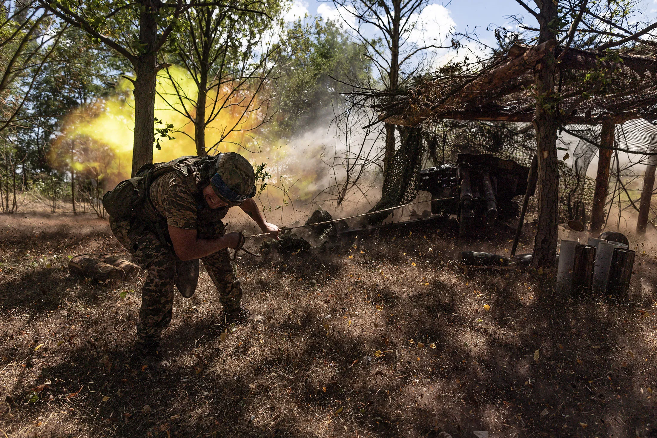 Ukrainian soldiers fire toward Russian positions in the Donetsk region in July.