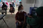 A woman receives a Covid vaccine at a health center in Jakarta, Indonesia, in January.