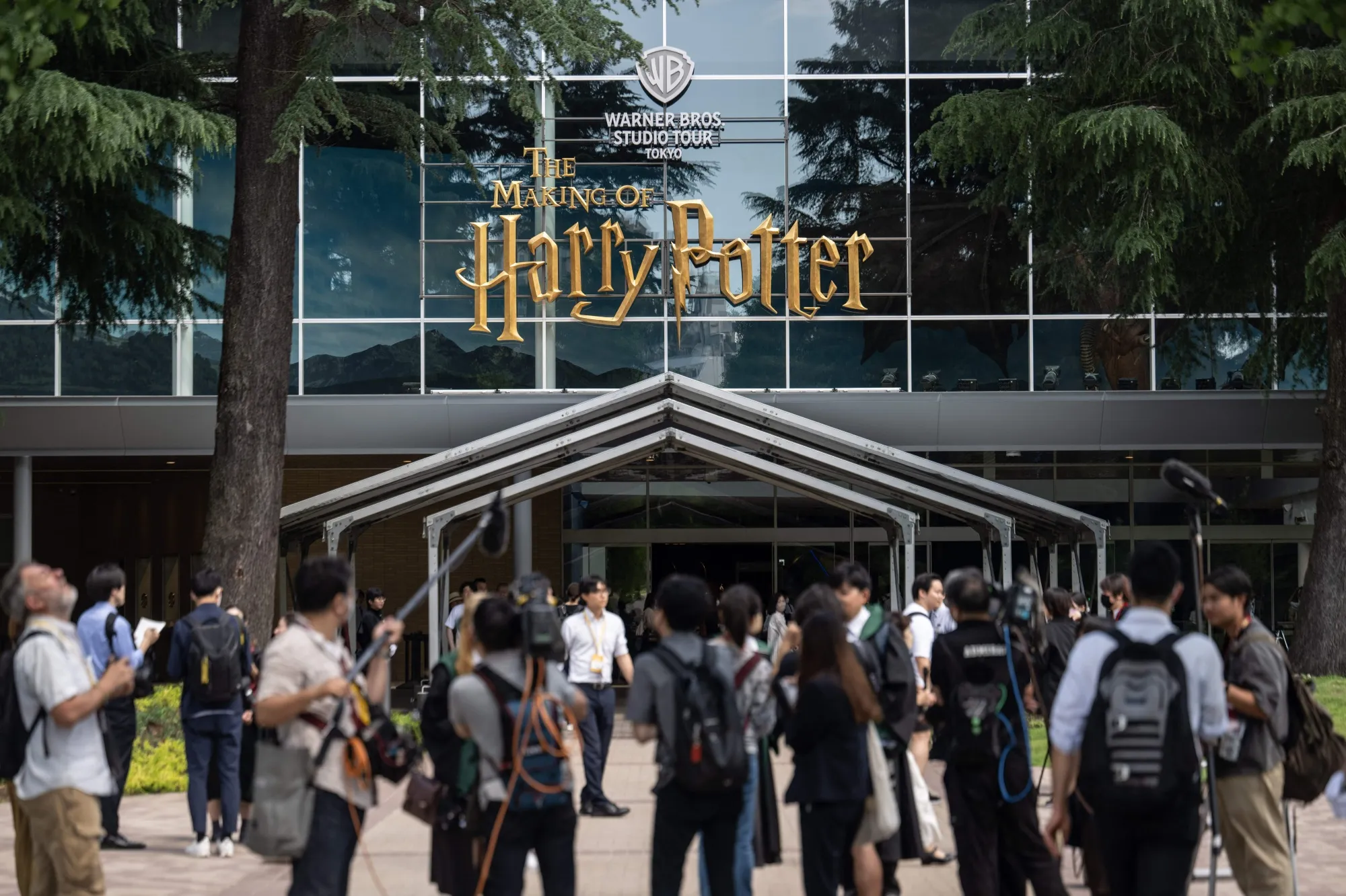 Pedestrians gather at the entrance of the theme park “Warner Bros. Studio Tour Tokyo - The Making of Harry Potter” in Tokyo, in June 2023.