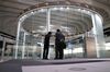 Visitors stands in front of an electronic ticker at the Tokyo Stock Exchange (TSE), operated by Japan Exchange Group Inc. (JPX), in Tokyo, Japan, on Monday, Nov. 30, 2020. TSE president Koichiro Miyahara will step down to accept responsibility for the all-day outage that halted trading on the world’s third-largest equity market last month.