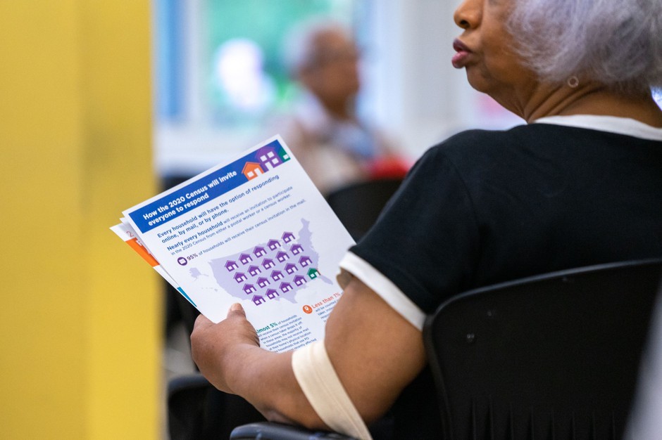 A jobseeker holds an information packet during a U.S. Census Bureau 2020 job opportunities workshop in 2019. Coronavirus fears could complicate the already difficult task of hiring enough census takers.
