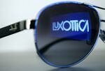 The EssilorLuxottica logo reflected on a pair of sunglasses.