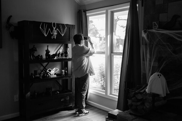 Kosareva uses her binoculars to watch birds in her backyard. 