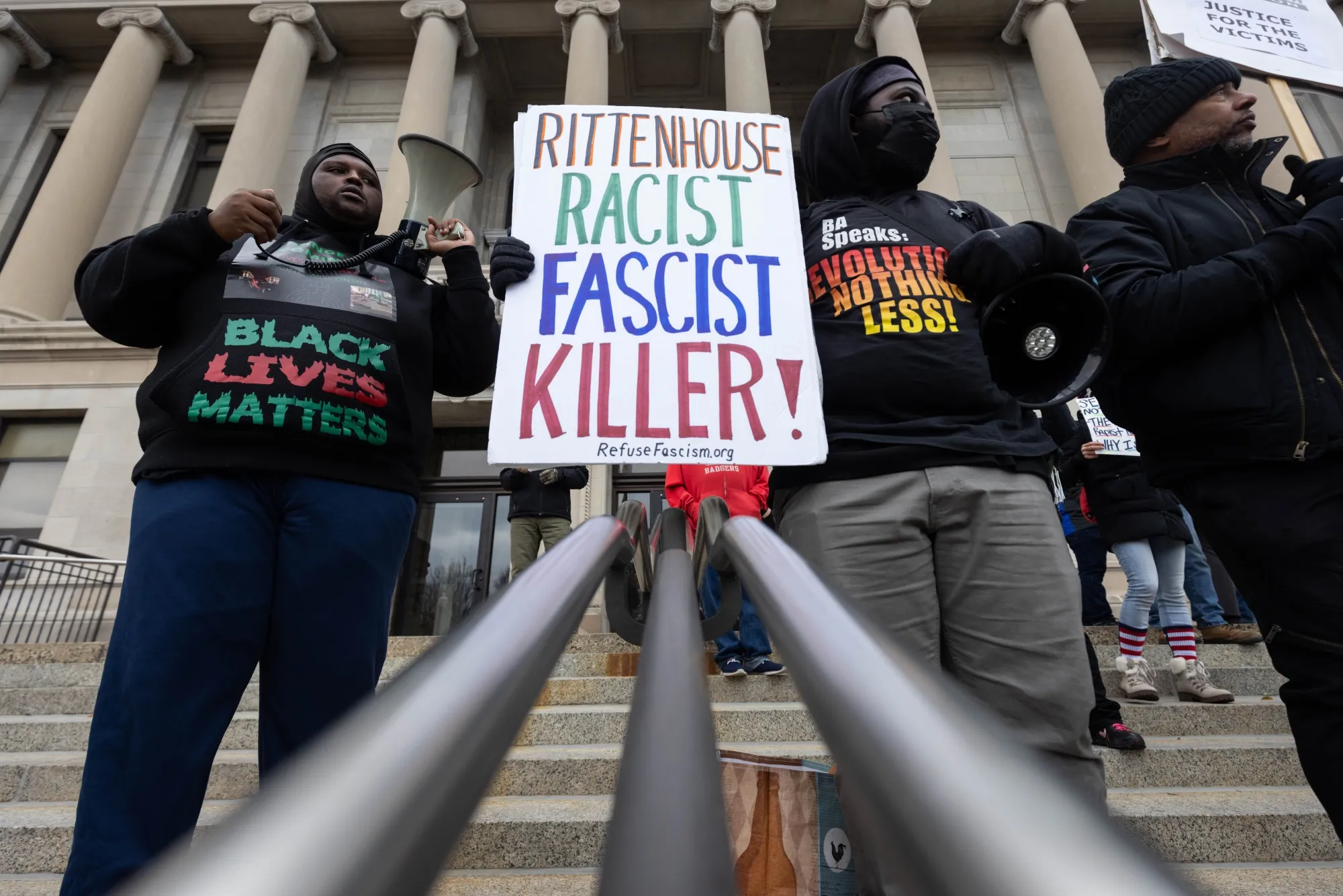 Demonstrators hold signs outside of the Kenosha County Courthouse during closing arguments in the Kyle Rittenhouse trial in Kenosha, Wisconsin, U.S., on&nbsp;Nov. 16.