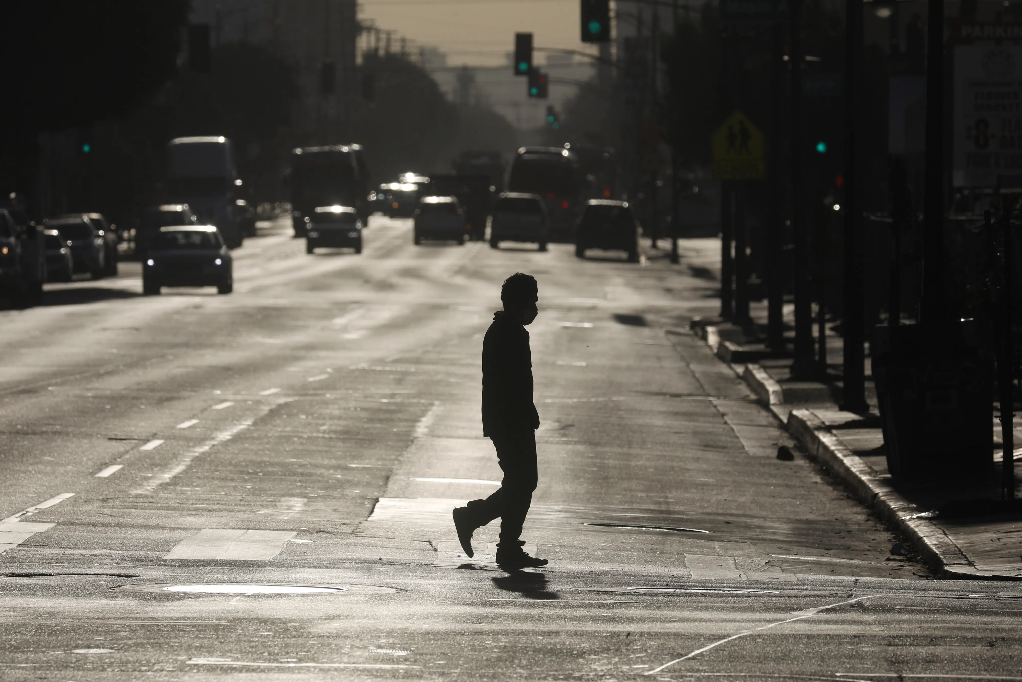 A pedestrian crosses a street in downtown Los Angeles on Dec. 3.