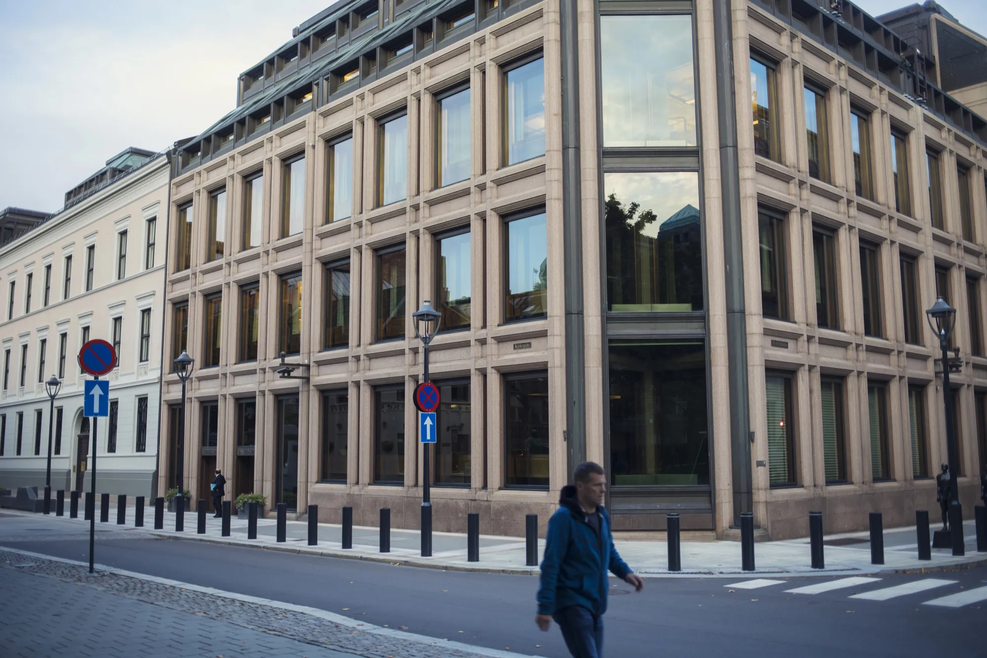 A pedestrian walks past the headquarters of Norway's central bank in Oslo, Norway.