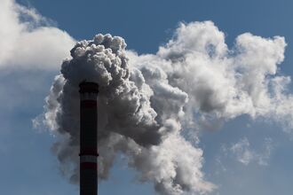 Smoke Rises From A Chimney