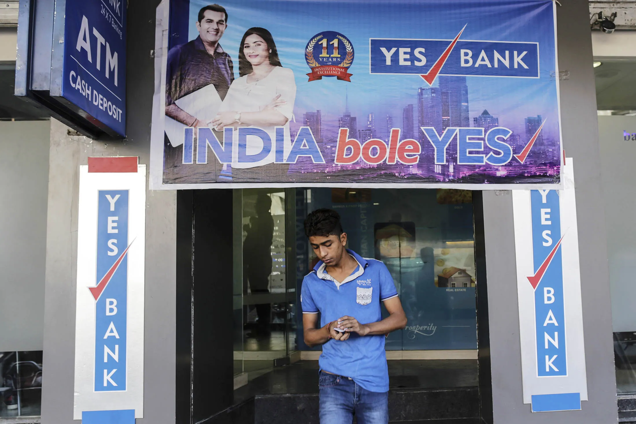 A customer exits a Yes Bank branch in Gujarat.
