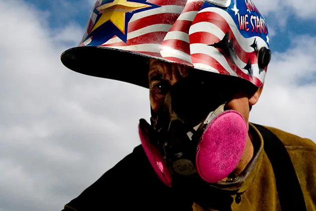 A contractor prepares to put up fixtures for solar panels at the Civita housing development construction site in San Diego, California.