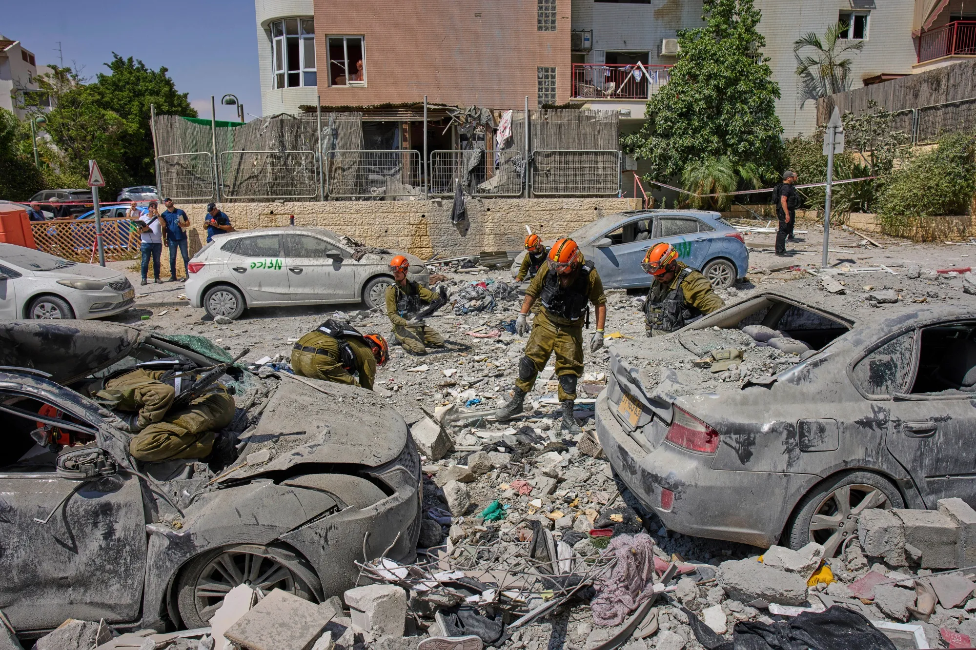 Israeli soldiers work in the rubble after an Iranian missile strike in Beersheba, Israel, on June 24.