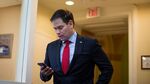 Sen. Marco Rubio (R-FL) checks his mobile phone as he arrives for a news conference to introduce a proposal for an overhaul of the tax code, March 4, 2015 on Capitol Hill in Washington, DC.
