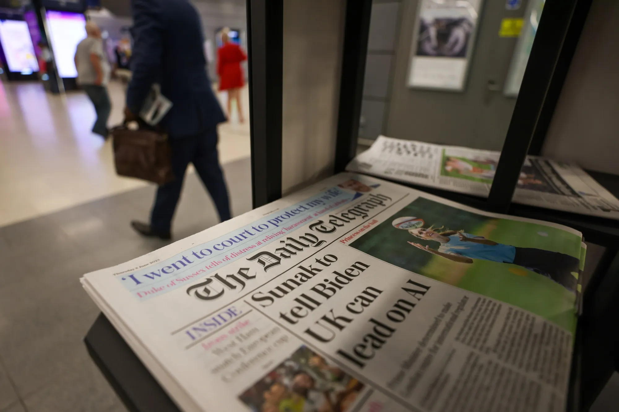 Copies of The Daily Telegraph newspaper on a newsstand in a shop in London, UK, on Thursday, June 8, 2023. The Telegraph newspapers and Spectator magazine could be sold, after a unit of Lloyds Banking Group Plc appointed receivers to a holding company and removed Barclay family members as directors of the media companies.
