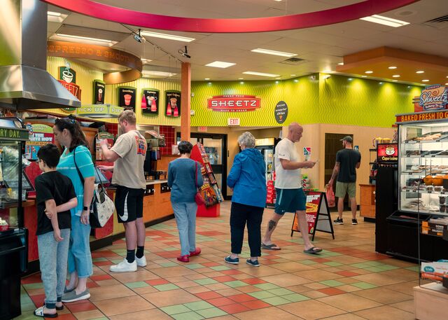 Customers inside of a Sheetz gas station store. 