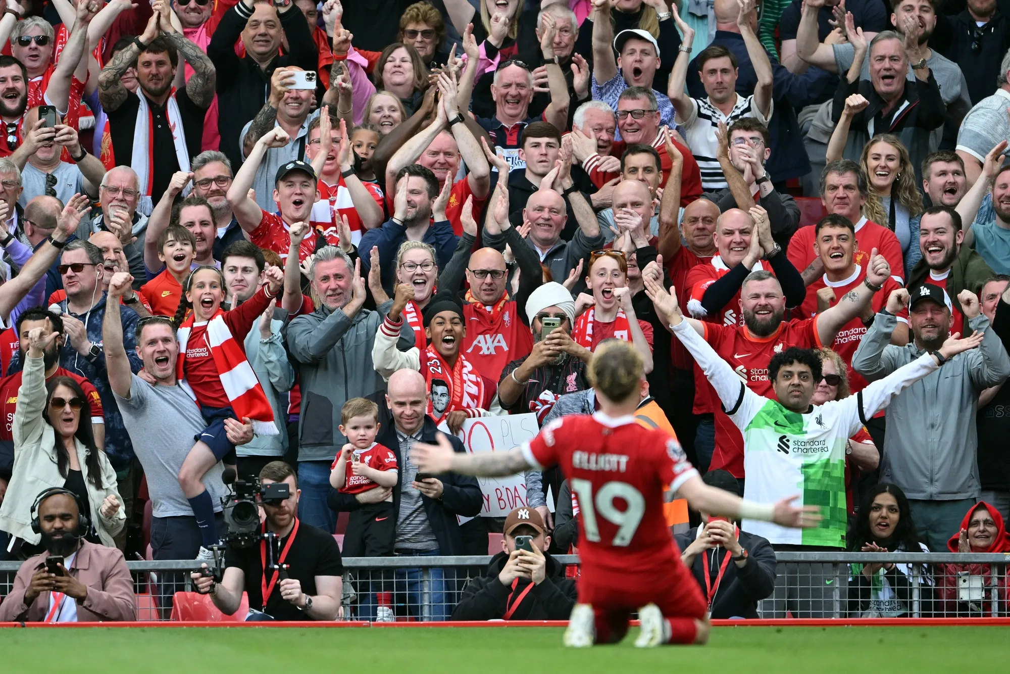 Fans celebrate with Liverpool’s Harvey Elliott following a goal during the Premier League match between Liverpool FC and Tottenham Hotspur on May 5.