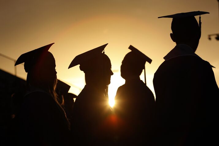 Santa Monica College graduates are silhouetted at sunset as they line up to receive their diplomas