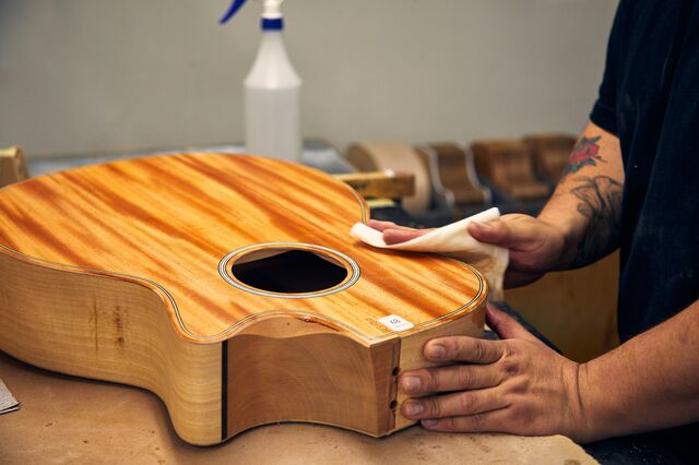 A worker shapes and sands a guitar for Taylor, which this year will build about 150,000 guitars in El Cajon, California, and Tecate, Mexico.