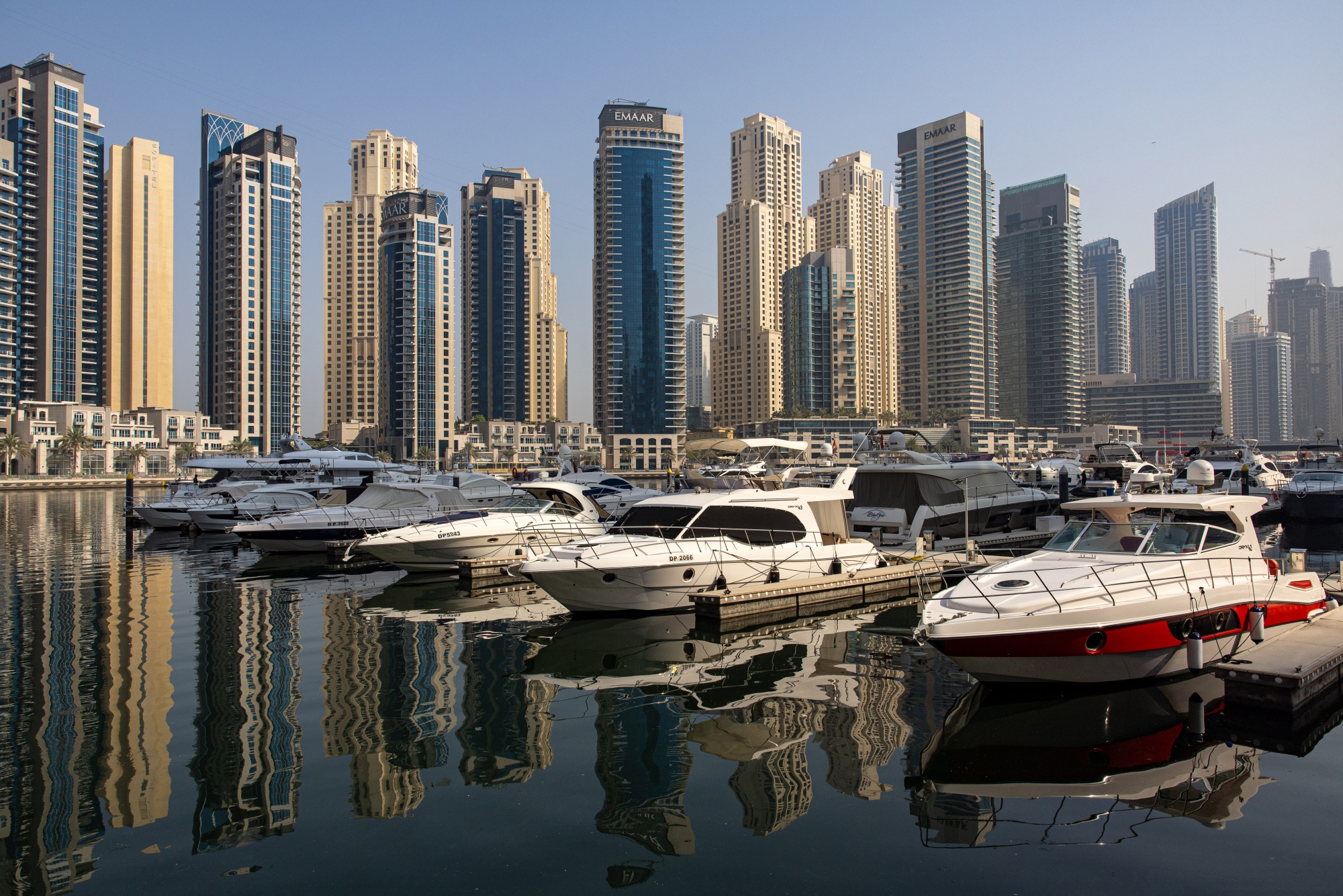 motor yachts docked in the Dubai Marina district of Dubai, United Arab Emirates