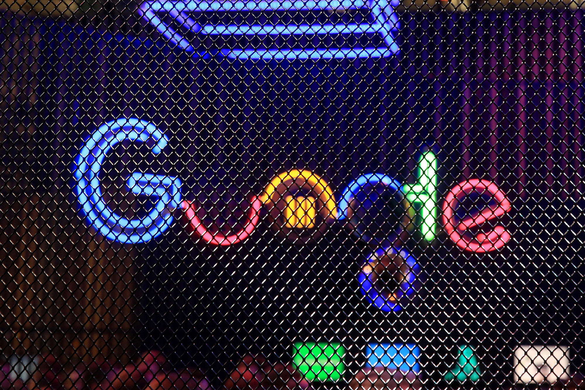 The Google Inc. logo hangs illuminated at the company's exhibition stand at the Dmexco digital marketing conference in Cologne, Germany.