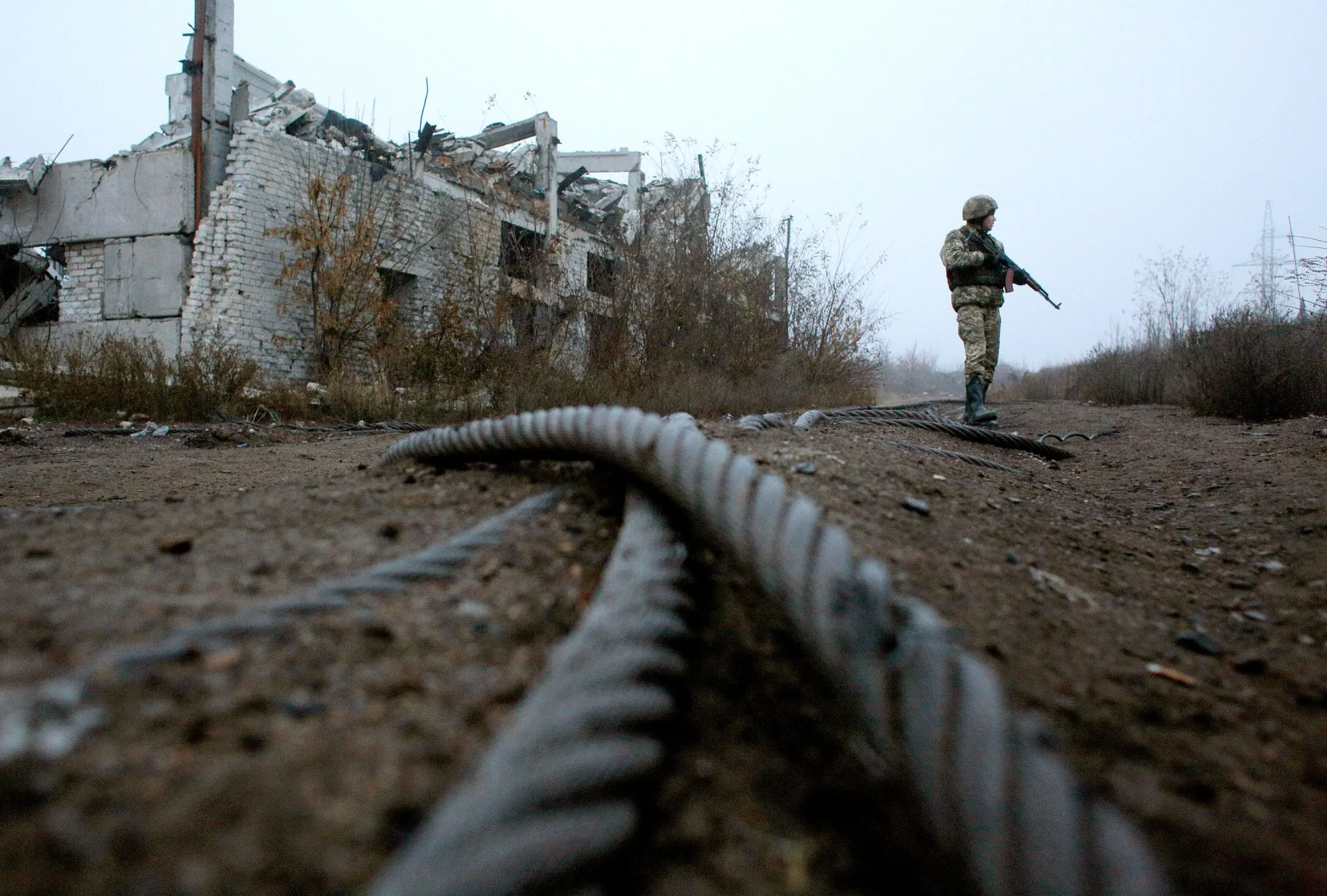 A Ukrainian serviceman patrols by a destroyed coal mine on the front line with Russia-backed separatists near Avdiivka, Donetsk.