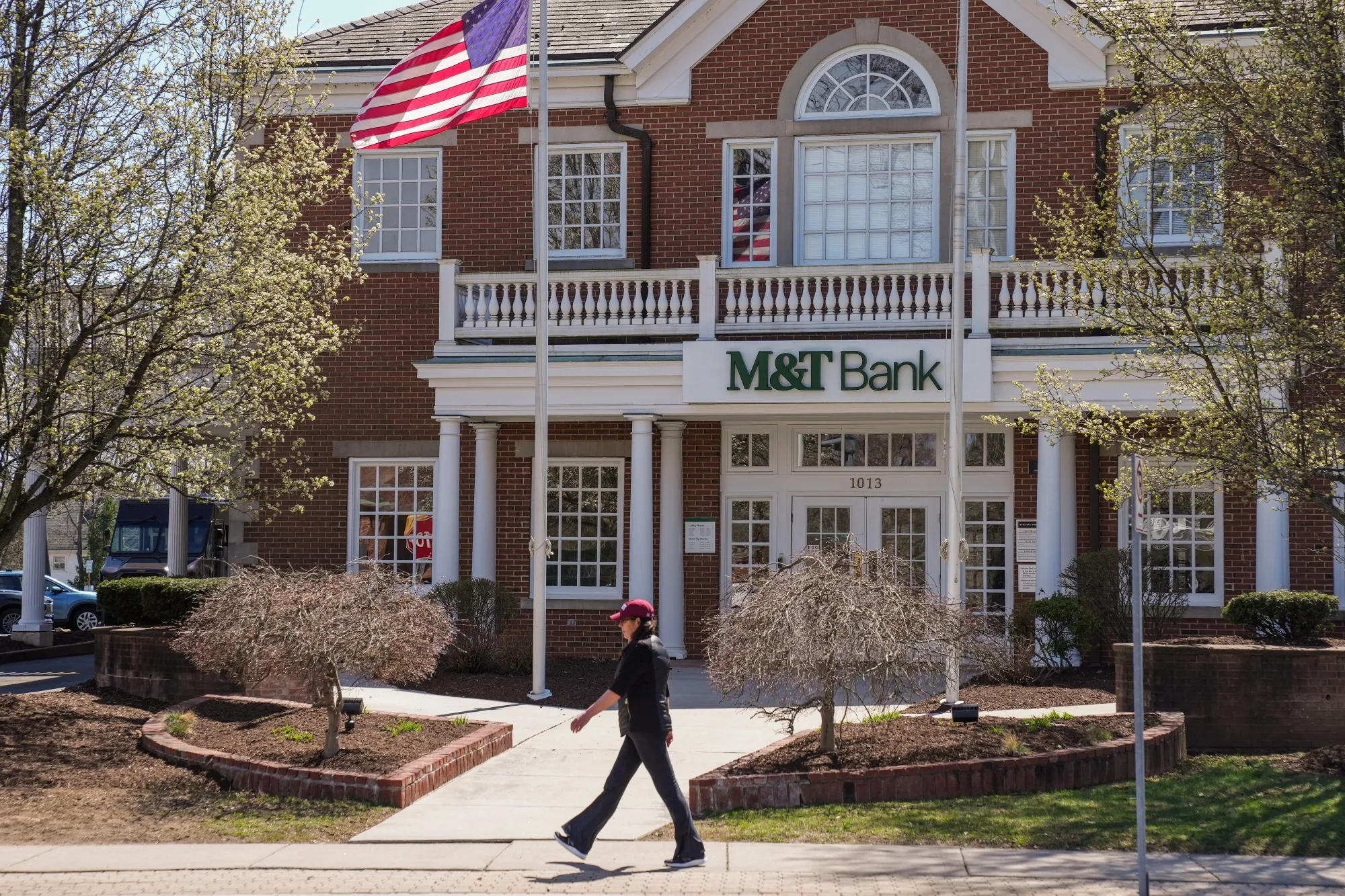 A pedestrian passes an M&amp;T Bank branch in West Hartford, Connecticut.