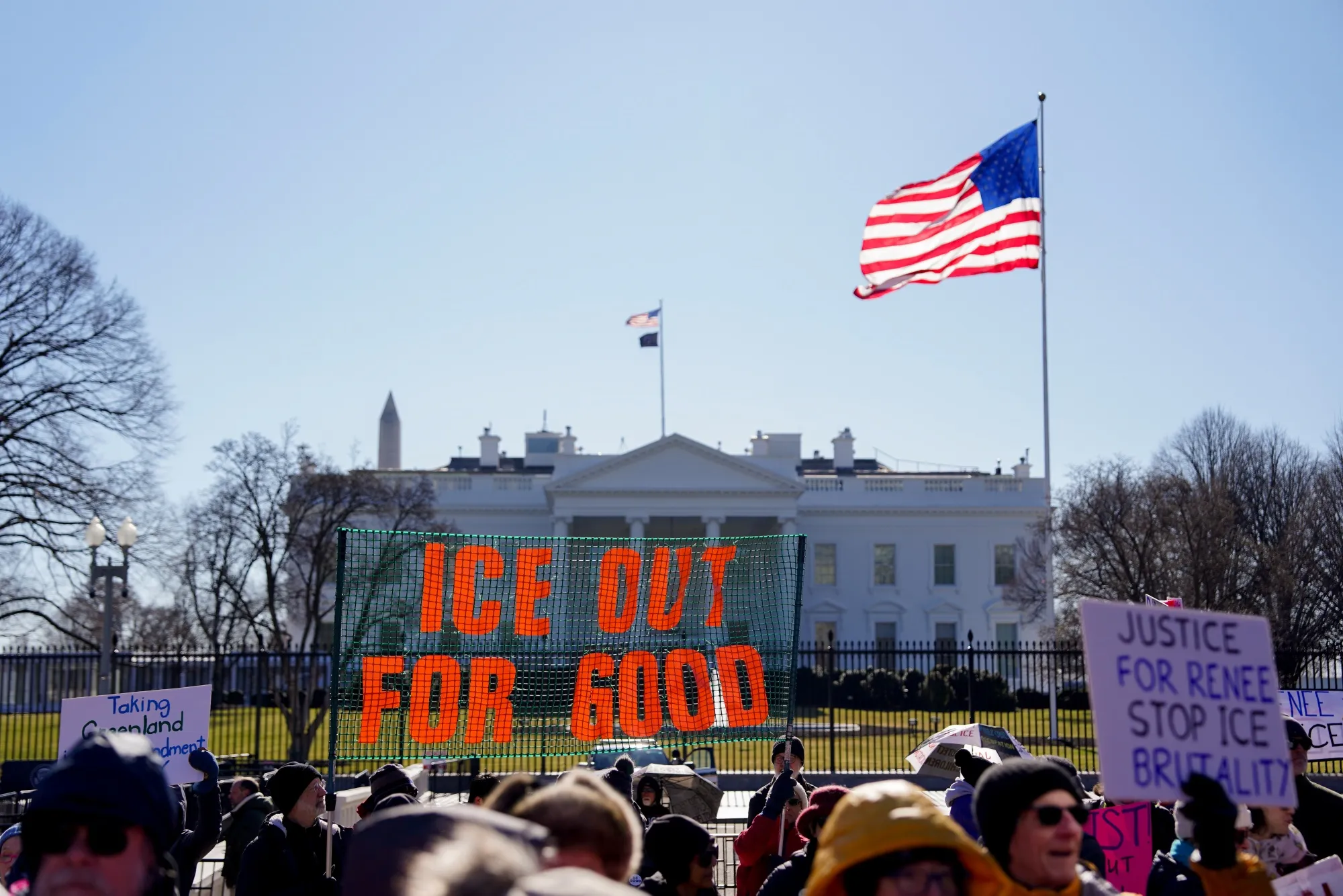 Demonstrators hold an "ICE Out For Good" sign during a protest against Trump administration policies near the White House in Washington on Jan. 20.